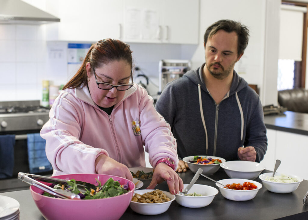 Individuals preparing a meal in supported accommodation